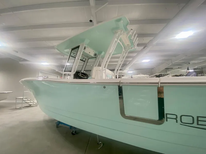 Slide: The Image of 2024 Robalo R270 boat in showroom, side view. - 3