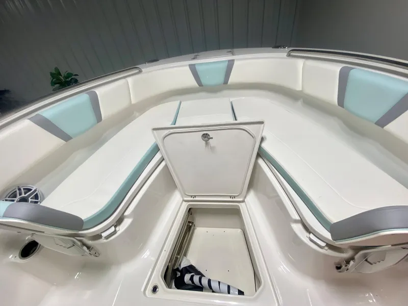 Slide: The Image of 2024 Robalo R270 boat interior with cushioned seating and storage compartments. - 30