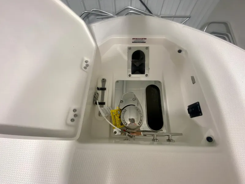 Slide: The Image of 2024 Robalo R270 boat anchor storage compartment with lid open. - 35