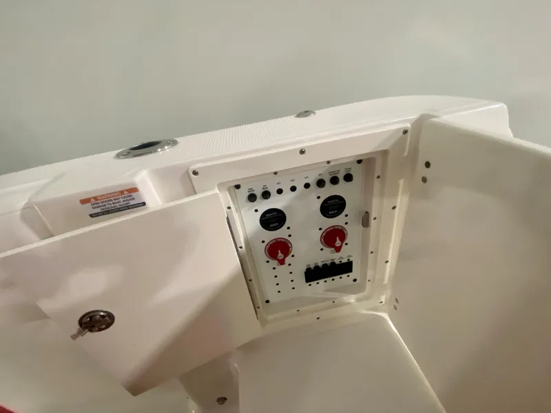 Slide: The Image of 2024 Robalo R270 boat control panel with switches and dials. - 7