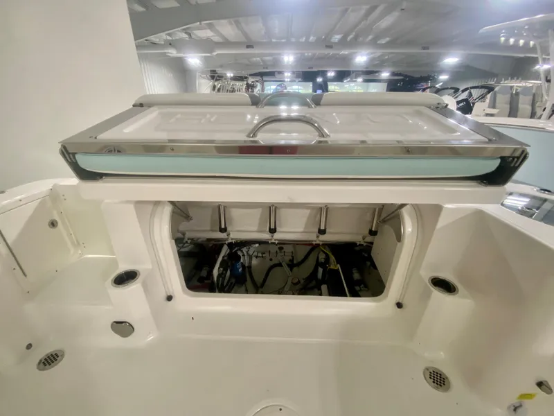 Slide: The Image of 2024 Robalo R270 boat interior with open storage compartment in showroom. - 9