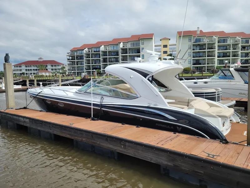 The Image of 2011 Formula 400ss luxury yacht docked at marina with waterfront condos in background. - 1