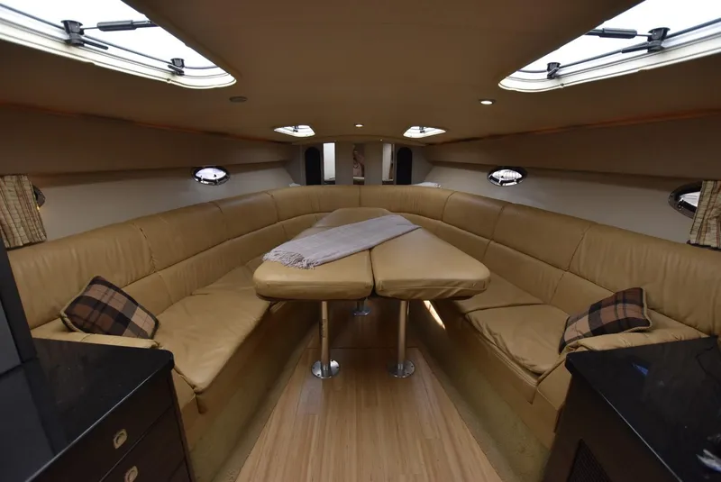 Slide: The Image of Interior of 2011 Formula 400ss boat with beige leather seating and wooden flooring. - 12