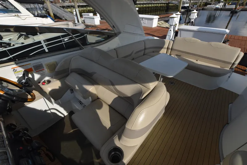 Slide: The Image of 2011 Formula 400ss boat interior with beige seating and a small table. - 8