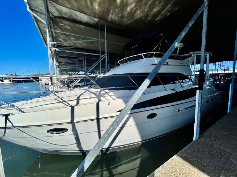 Slide: The Image of 2008 Meridian 459 Motoryacht docked under a marina canopy. - 13