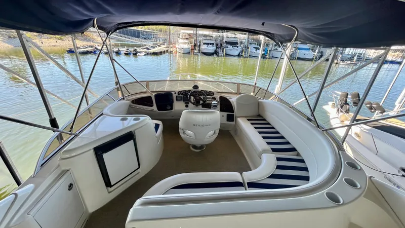 Slide: The Image of 2008 Meridian 459 Motoryacht helm and seating area with marina view. - 20