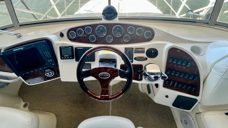 Slide: The Image of 2008 Meridian 459 Motoryacht helm with navigation instruments and wood-trimmed steering wheel. - 22