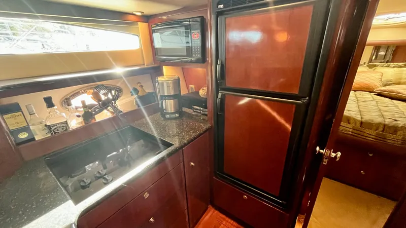 Slide: The Image of 2008 Meridian 459 Motoryacht kitchen with granite countertops, microwave, and refrigerator. - 31