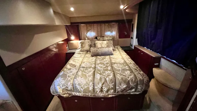 Slide: The Image of Luxurious bedroom in a 2008 Meridian 459 Motoryacht with elegant bedding and ambient lighting. - 38
