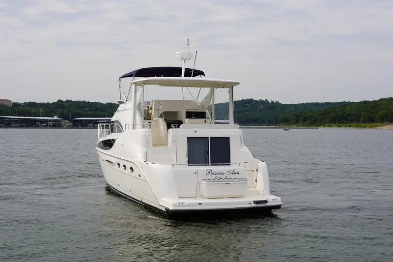 Slide: The Image of 2008 Meridian 459 Motoryacht on a serene lake with lush green shoreline. - 5