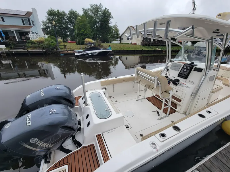 Slide: The Image of 2016 Sea Fox 266 Commander boat with dual Yamaha 150 engines docked by a canal. - 10