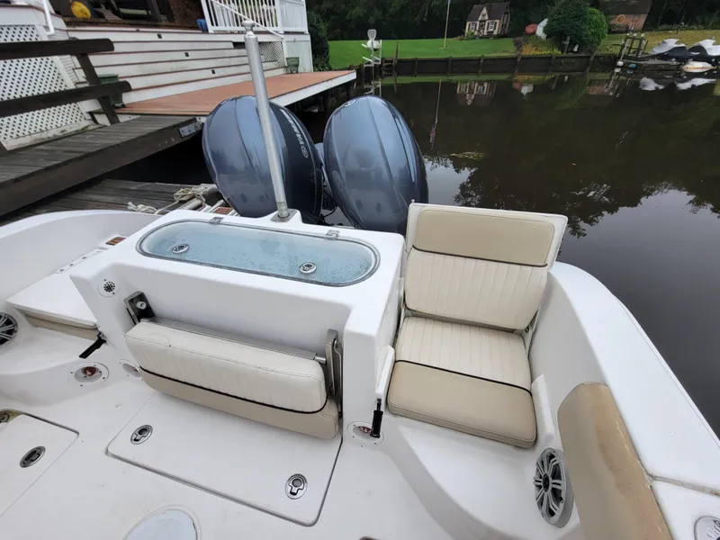 Slide: The Image of 2016 Sea Fox 266 Commander boat with twin engines and seating area by the dock. - 11