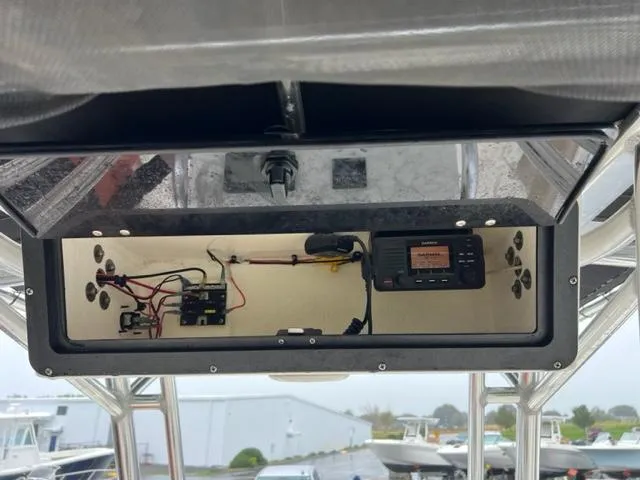 Slide: The Image of 2020 Key West 239 FS boat electronics compartment with wiring and radio. - 11