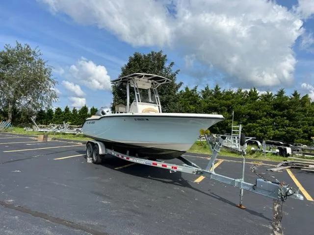Slide: The Image of 2020 Key West 239 FS boat on a trailer in a parking lot. - 2
