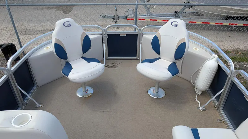 Slide: The Image of 2016 Avalon 2480 QF boat interior with two swivel chairs and safety railing. - 16