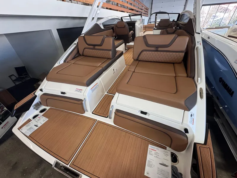 Slide: The Image of 2024 Yamaha Boats 275 SD with luxurious brown seating and spacious deck. - 2
