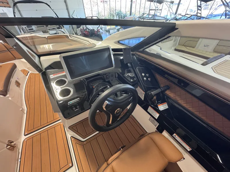Slide: The Image of 2024 Yamaha Boats 275 SD cockpit with modern dashboard and steering wheel. - 4