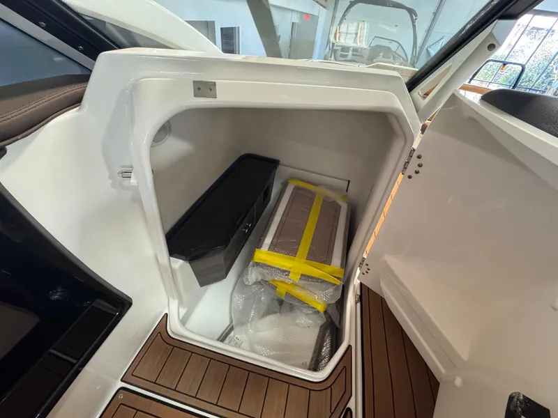 Slide: The Image of Storage compartment of 2024 Yamaha Boats 275 SD with packaged items inside. - 6
