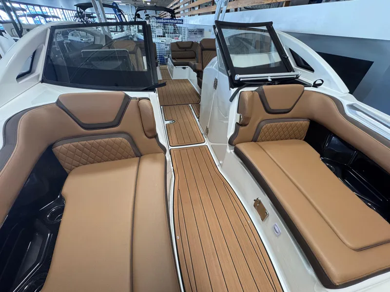 Slide: The Image of 2024 Yamaha Boats 275 SD interior with tan leather seating and sleek design. - 7