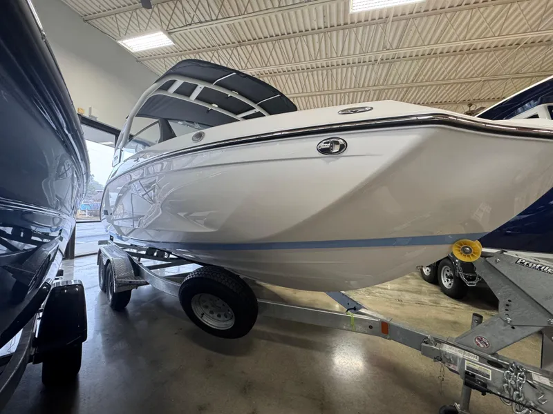 Slide: The Image of 2024 Yamaha Boats 222S on trailer in showroom, side view. - 1