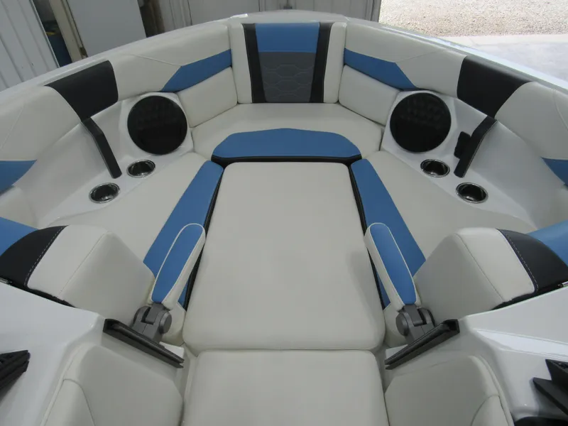 Slide: The Image of 2024 Malibu 23 LSV boat interior with blue and white seating. - 11