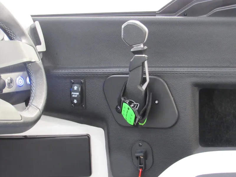 Slide: The Image of 2024 Malibu 23 LSV boat interior, featuring steering wheel and control panel. - 13