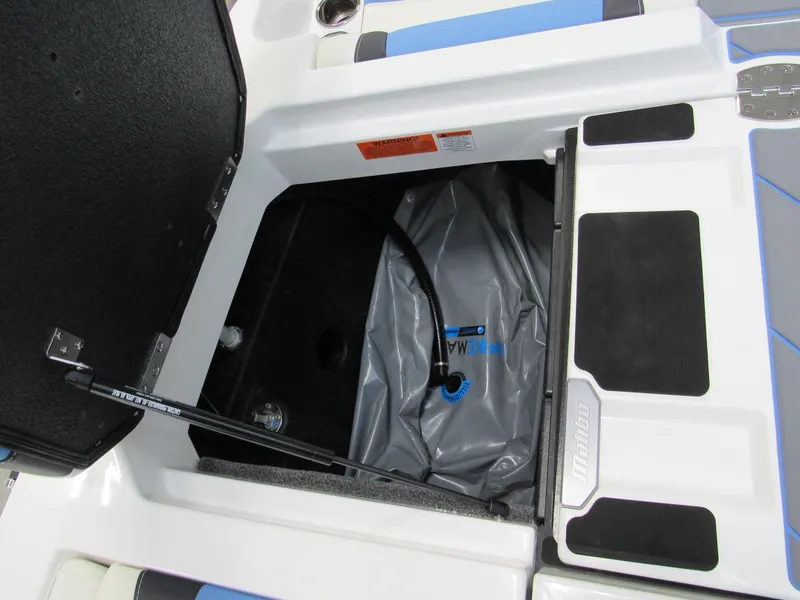 Slide: The Image of 2024 Malibu 23 LSV storage compartment with ballast bag. - 21