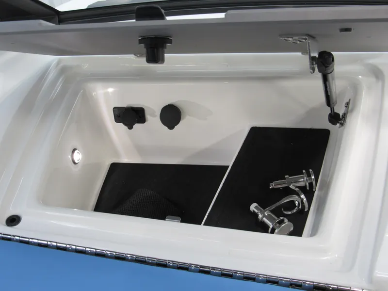 Slide: The Image of 2024 Malibu 23 LSV storage compartment with accessories and lighting. - 23
