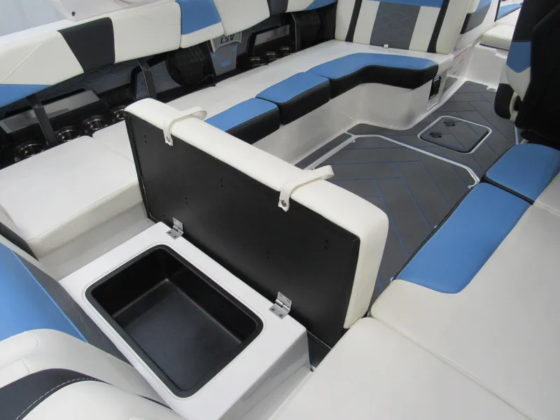 Slide: The Image of 2024 Malibu 23 LSV interior with blue and white seating and storage compartment. - 30