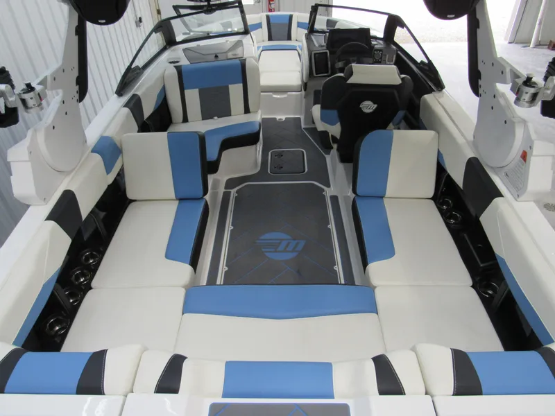 Slide: The Image of 2024 Malibu 23 LSV boat interior with blue and white seating. - 31