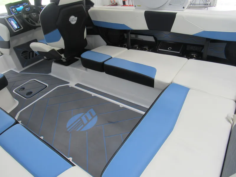 Slide: The Image of 2024 Malibu 23 LSV interior with blue and white seating and modern dashboard. - 6