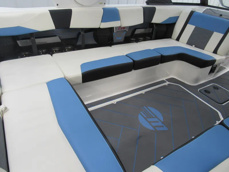 Slide: The Image of 2024 Malibu 23 LSV boat interior with blue and white seating. - 7