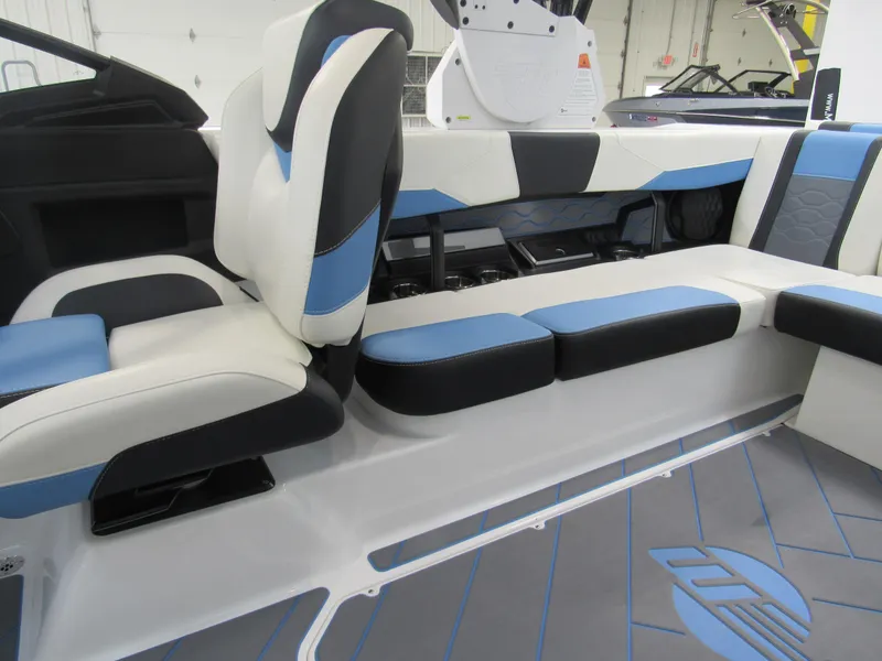 Slide: The Image of 2024 Malibu 23 LSV boat interior with blue and black seating. - 8