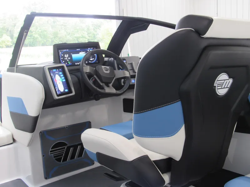 Slide: The Image of 2024 Malibu 23 LSV boat interior with modern dashboard and blue-accented seating. - 9
