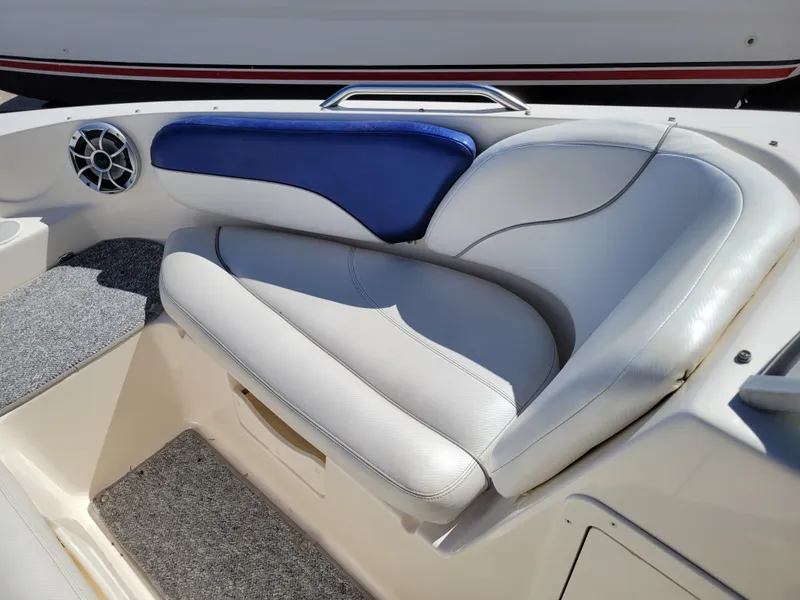 Slide: The Image of 2002 Rinker 212 BR boat interior seating with blue and white upholstery. - 18
