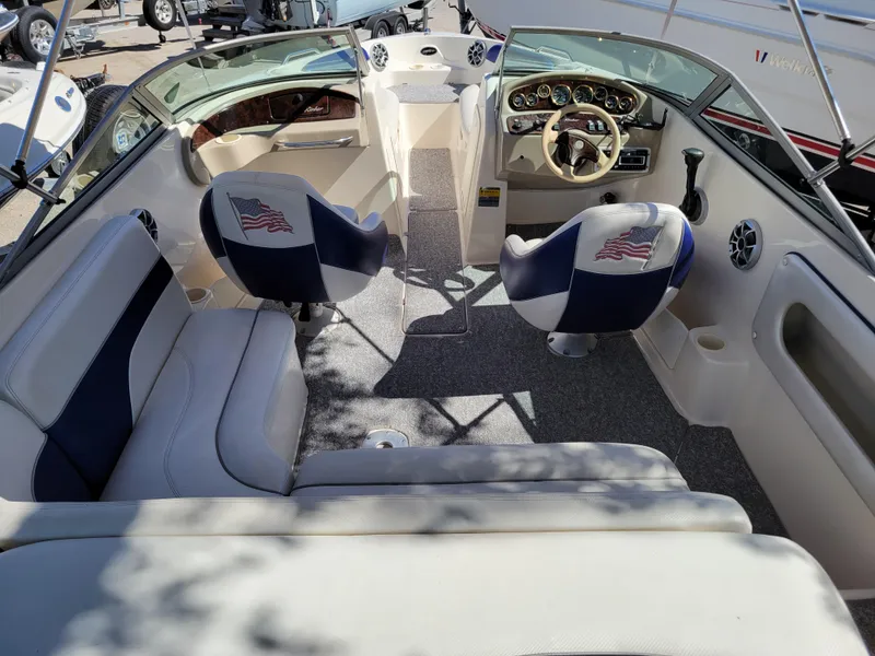 Slide: The Image of 2002 Rinker 212 BR boat interior with American flag-themed seats. - 5