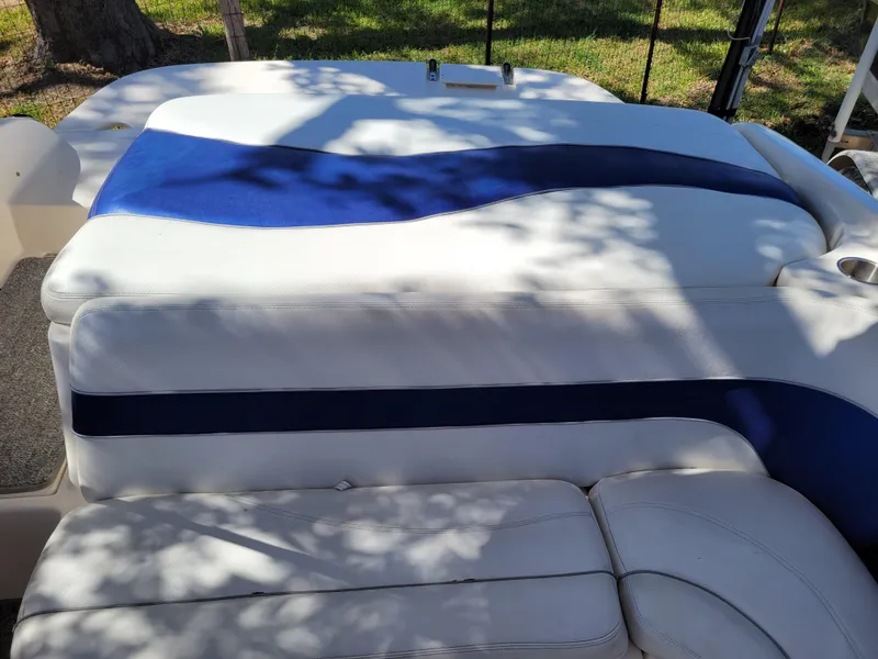Slide: The Image of 2002 Rinker 212 BR boat interior with white and blue upholstery. - 6