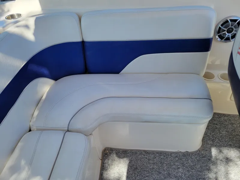Slide: The Image of 2002 Rinker 212 BR boat interior seating with blue and white upholstery. - 8