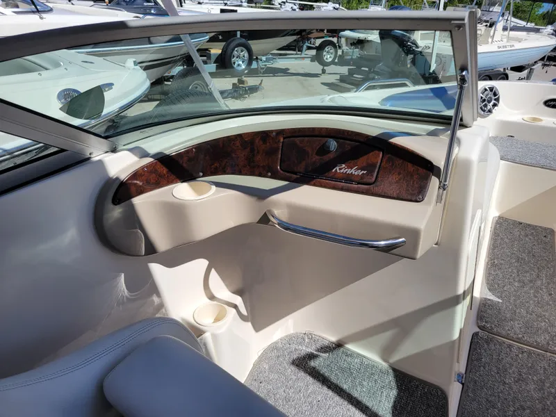 Slide: The Image of 2002 Rinker 212 BR boat interior with dashboard and seating area. - 9