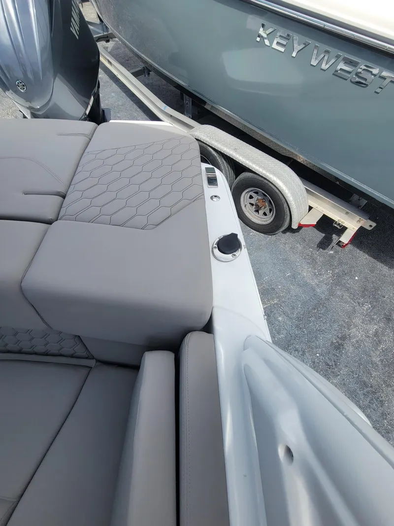 Slide: The Image of 2024 Four Winns H4 OB boat with gray cushioned seating and hexagonal pattern. - 18