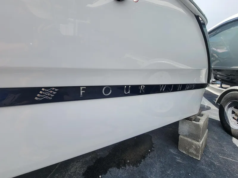 Slide: The Image of 2024 Four Winns H4 OB boat side view with logo. - 4