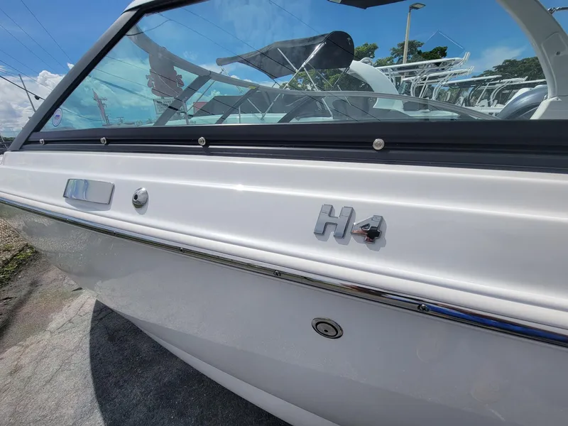 Slide: The Image of 2024 Four Winns H4 OB boat side view with logo and windshield. - 5