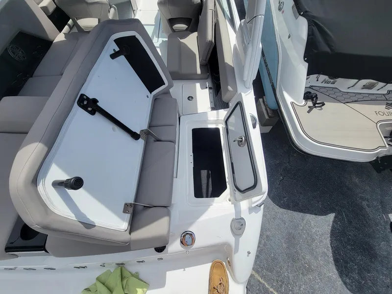 Slide: The Image of 2024 Four Winns H4 OB boat interior with open storage compartments and seating. - 9