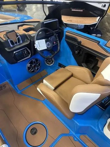 Slide: The Image of 2023 Axis Wake Research A225 boat interior with blue and brown design, featuring modern controls. - 3