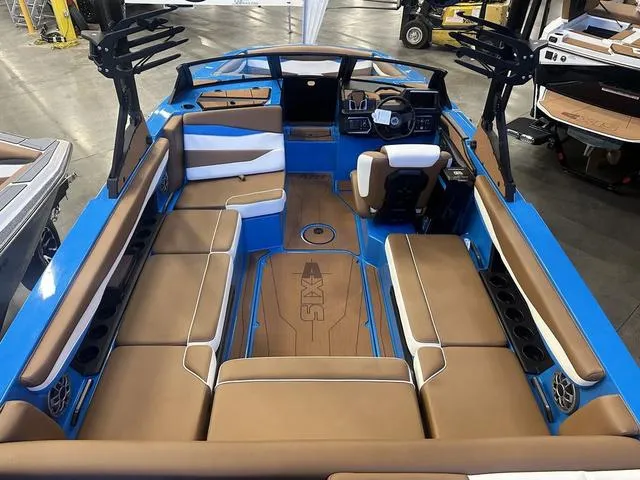 Slide: The Image of 2023 Axis Wake Research A225 boat interior with brown and blue seating. - 4