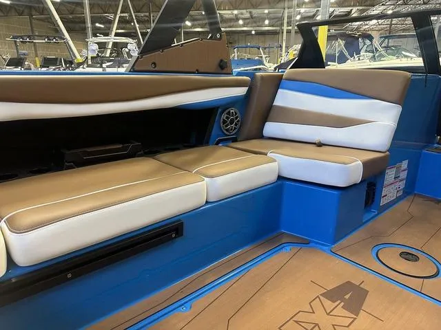 Slide: The Image of 2023 Axis Wake Research A225 boat interior with brown and white seating. - 5