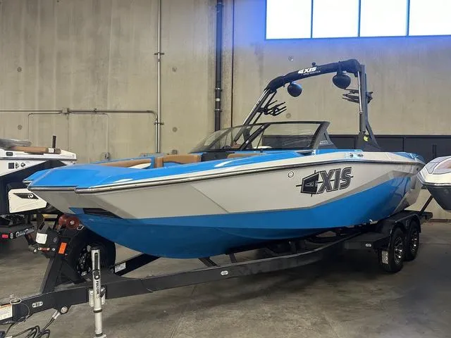 Slide: The Image of 2023 Axis Wake Research A225 boat in showroom, blue and white design. - 7