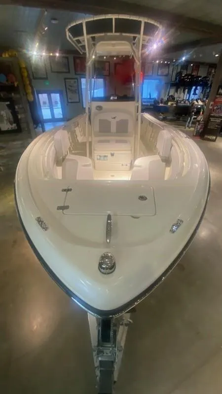 Slide: The Image of 2024 Mako 214 CC center console boat displayed indoors. - 4