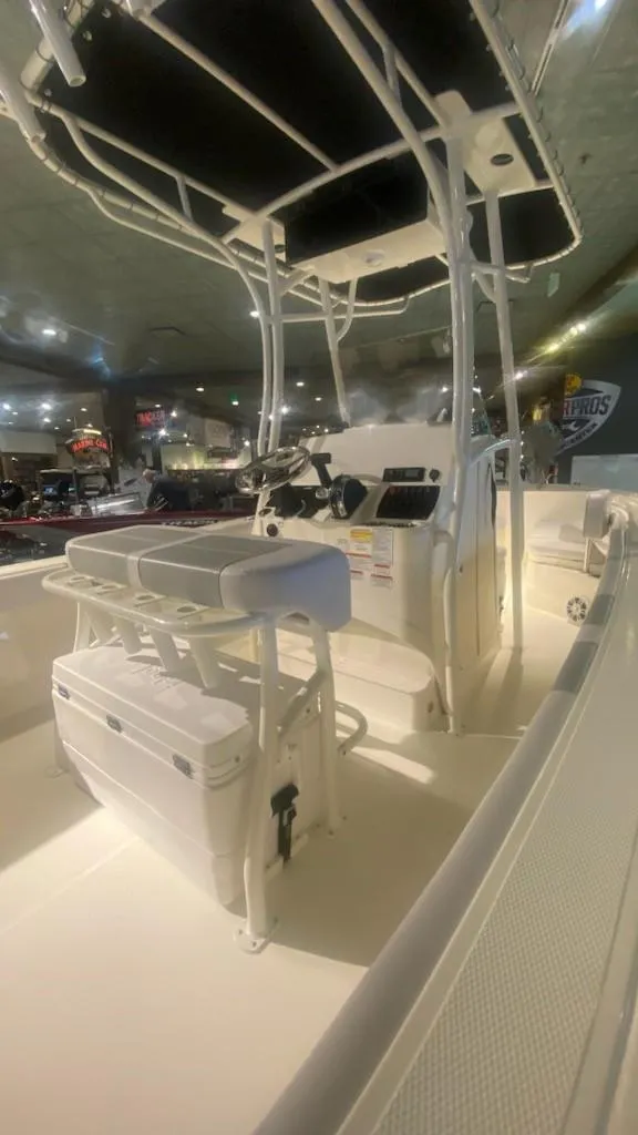 Slide: The Image of 2024 Mako 214 CC center console boat interior with T-top and seating. - 5