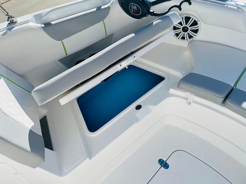 Slide: The Image of 2024 Tahoe 2150 CC boat interior with storage compartment open. - 12